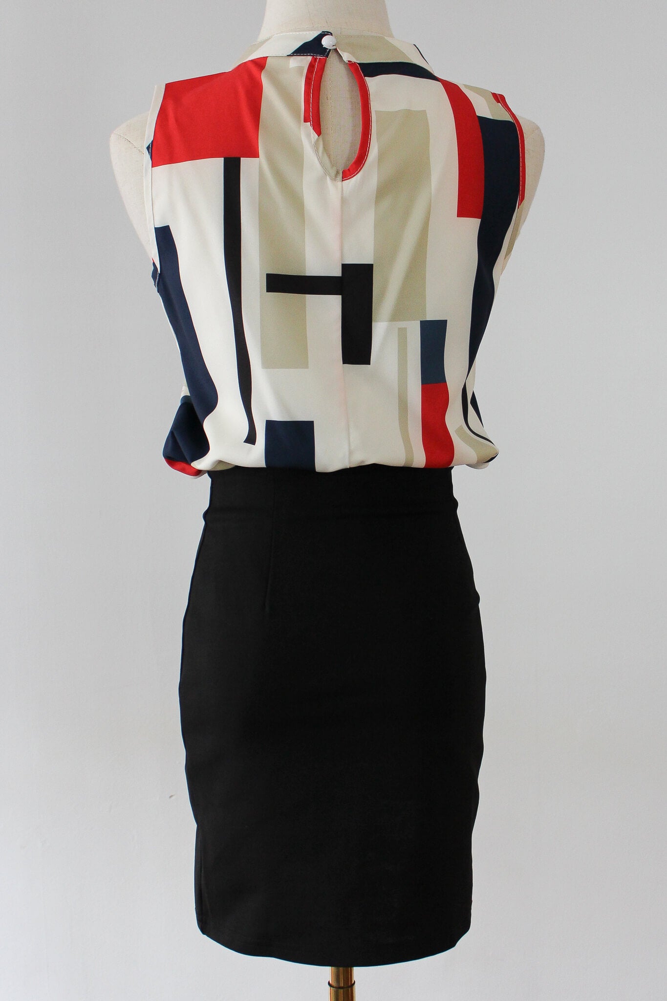 Colorblock blouse with ribboned skirt, perfect for work.