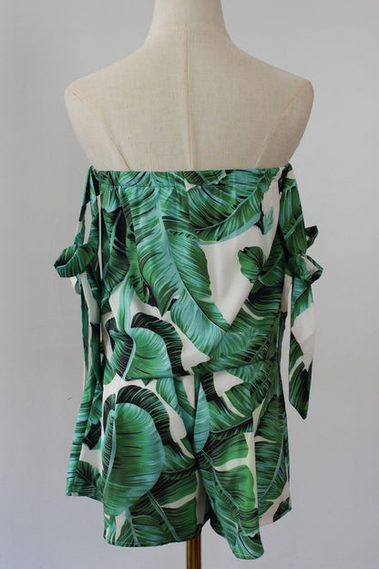 Two set piece containing strapless tube top with  tied ribbon sleeve and shorts. Leaf prints 